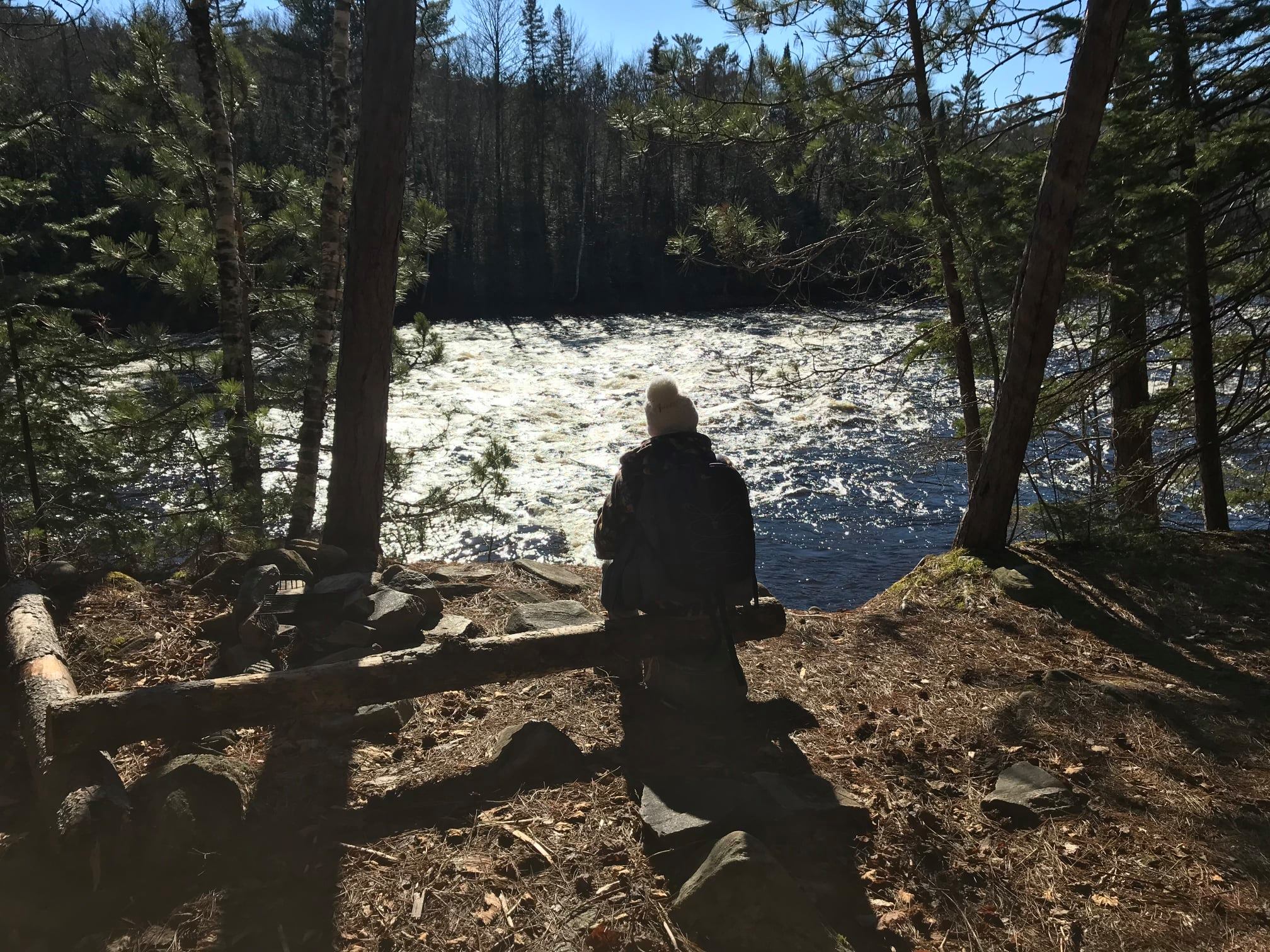 hiker taking a break by the Dumoine river